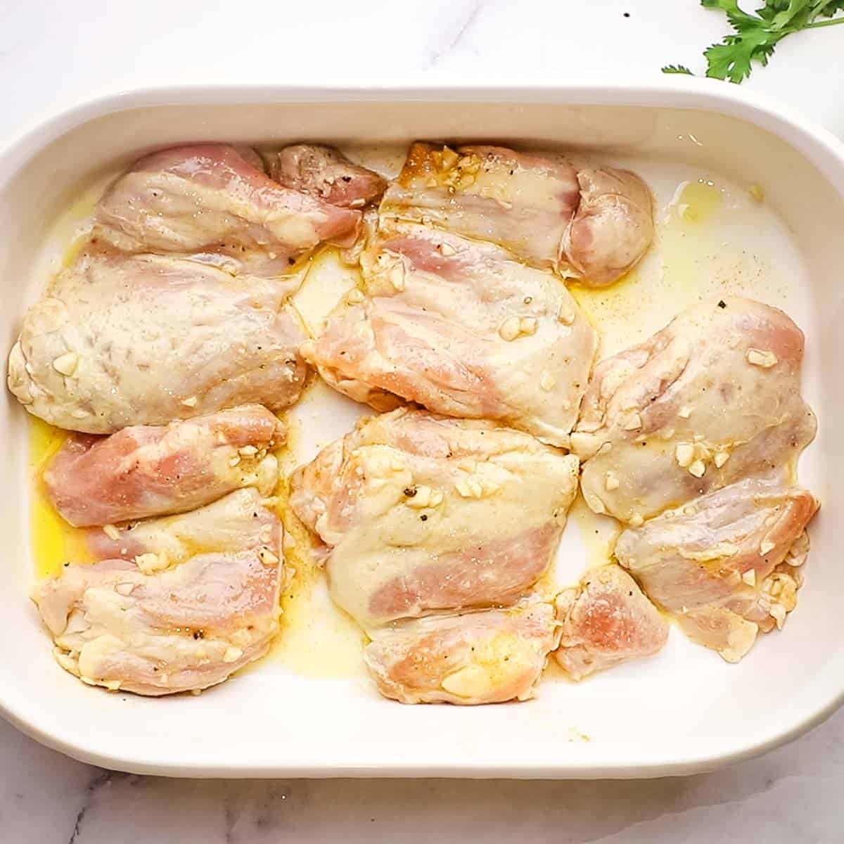 uncooked chicken in a large baking dish