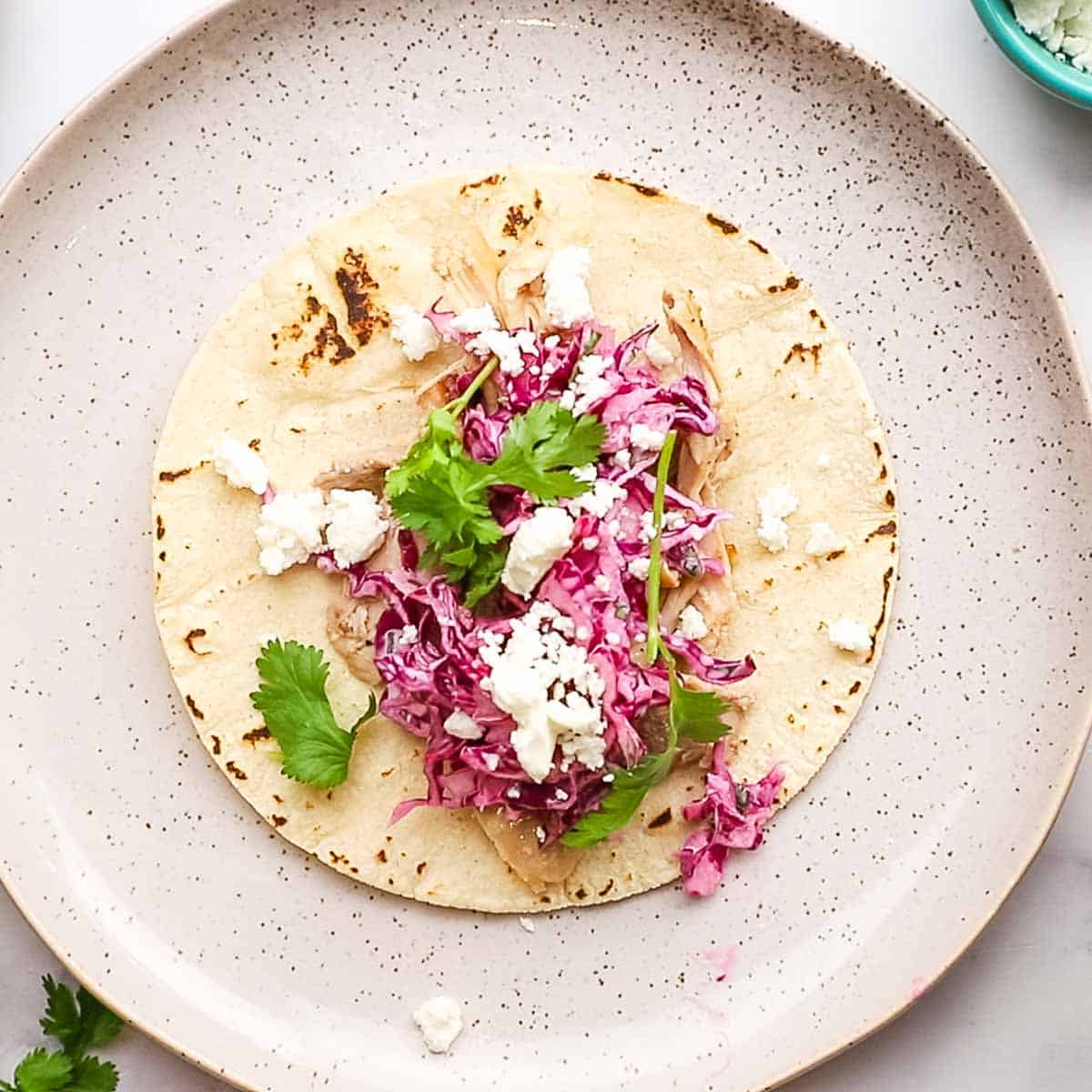 assembled chicken tacos with cilantro lime slaw