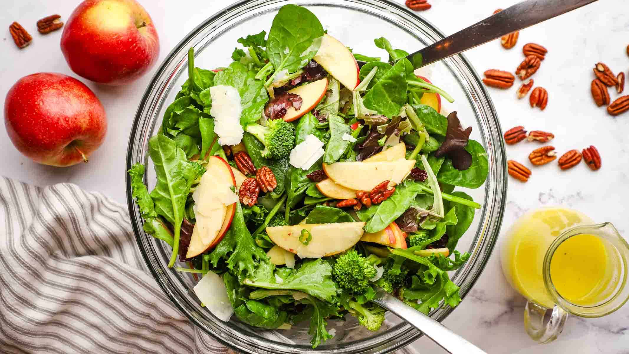 an overhead view of a dish of apple pecan salad