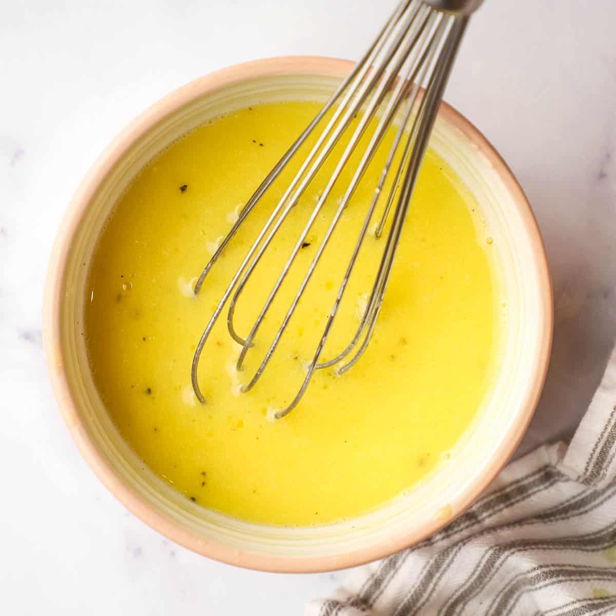 maple vinaigrette in a small bowl with a whisk