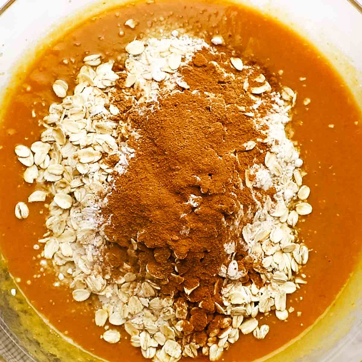 adding the dry ingredients to the wet ingredients in the large bowl