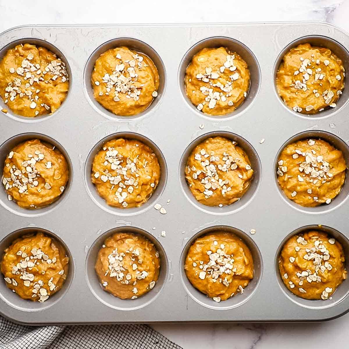 oatmeal muffin batter in a muffin tin