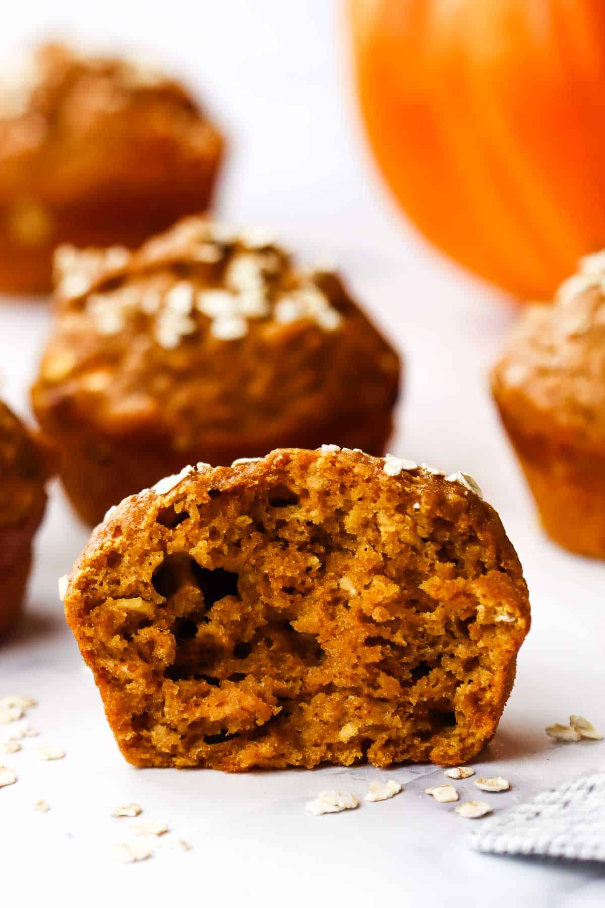 A pumpkin muffin halved to show the inside texture.