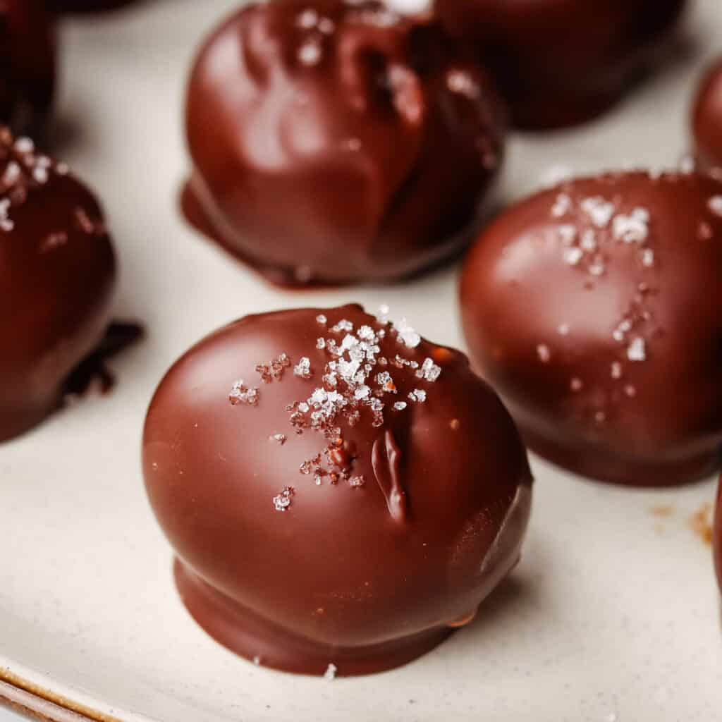 A closeup of a chocolate truffle srpinkled with sea salt.