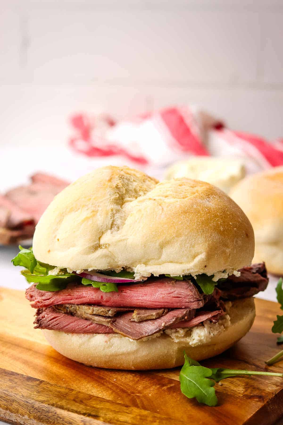 a roast beef sandwich on a cutting board