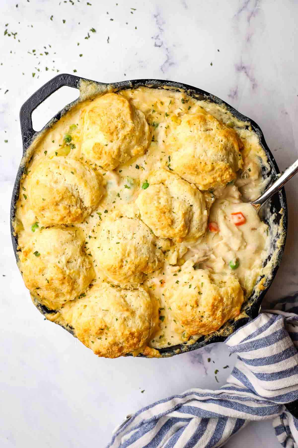 chicken pot pie in a skillet with a spoon in it