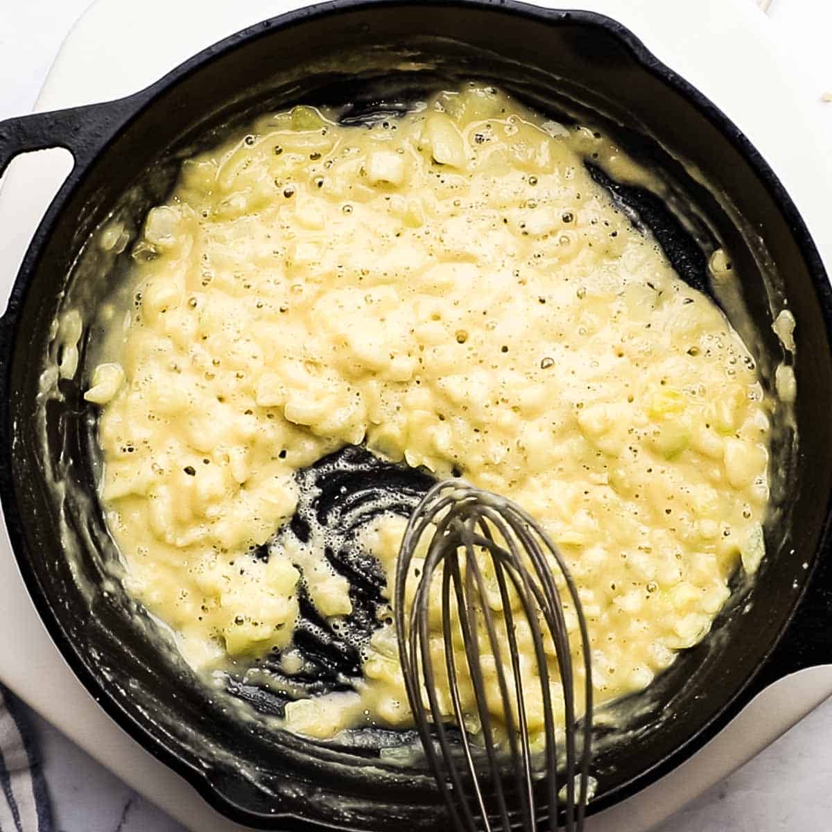 whisking the flour in the onions and butter