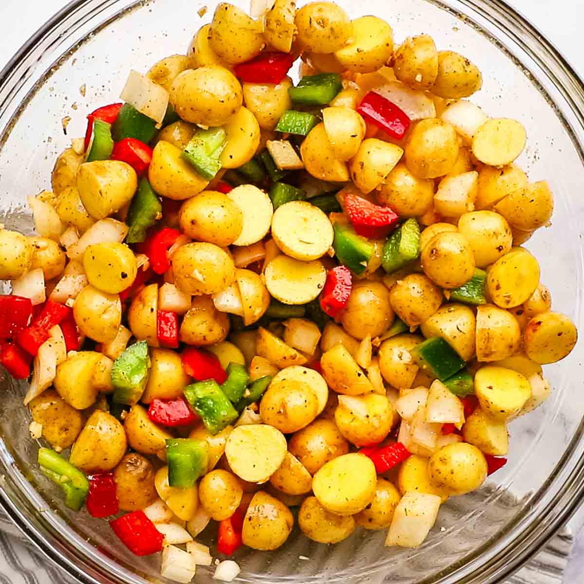 uncooked combined ingredients for country potatoes in a big bowl