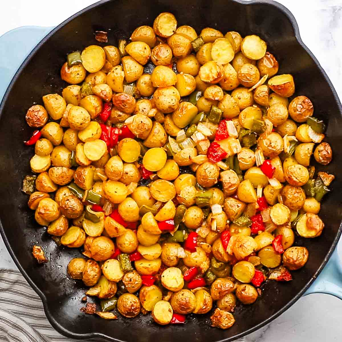 country potatoes halfway done in a large skillet