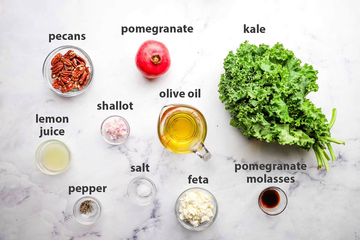 ingredients pictured and labelled for kale pomegranate salad