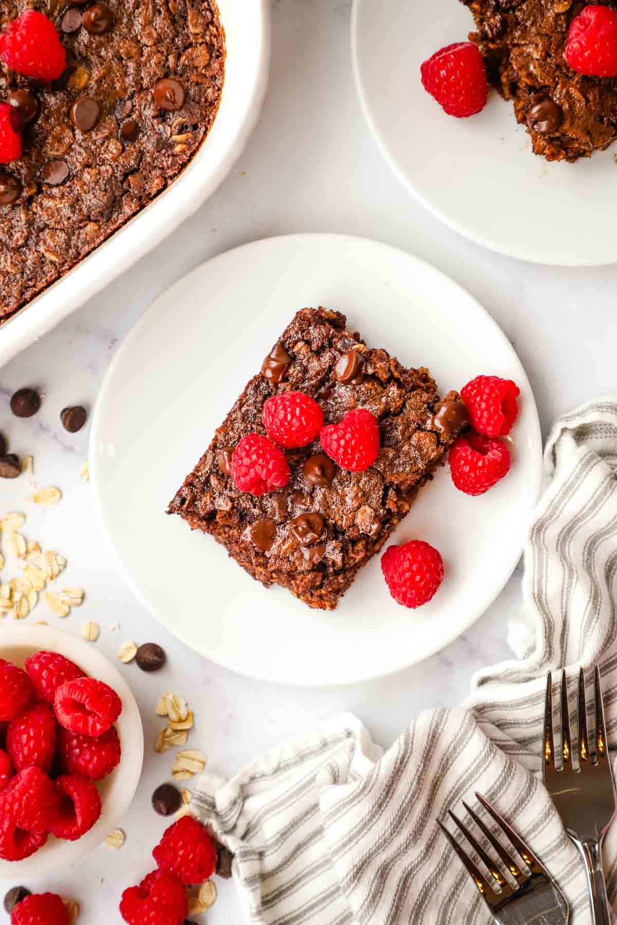 overhead view of a serving of chocolate baked oats topped with raspberries