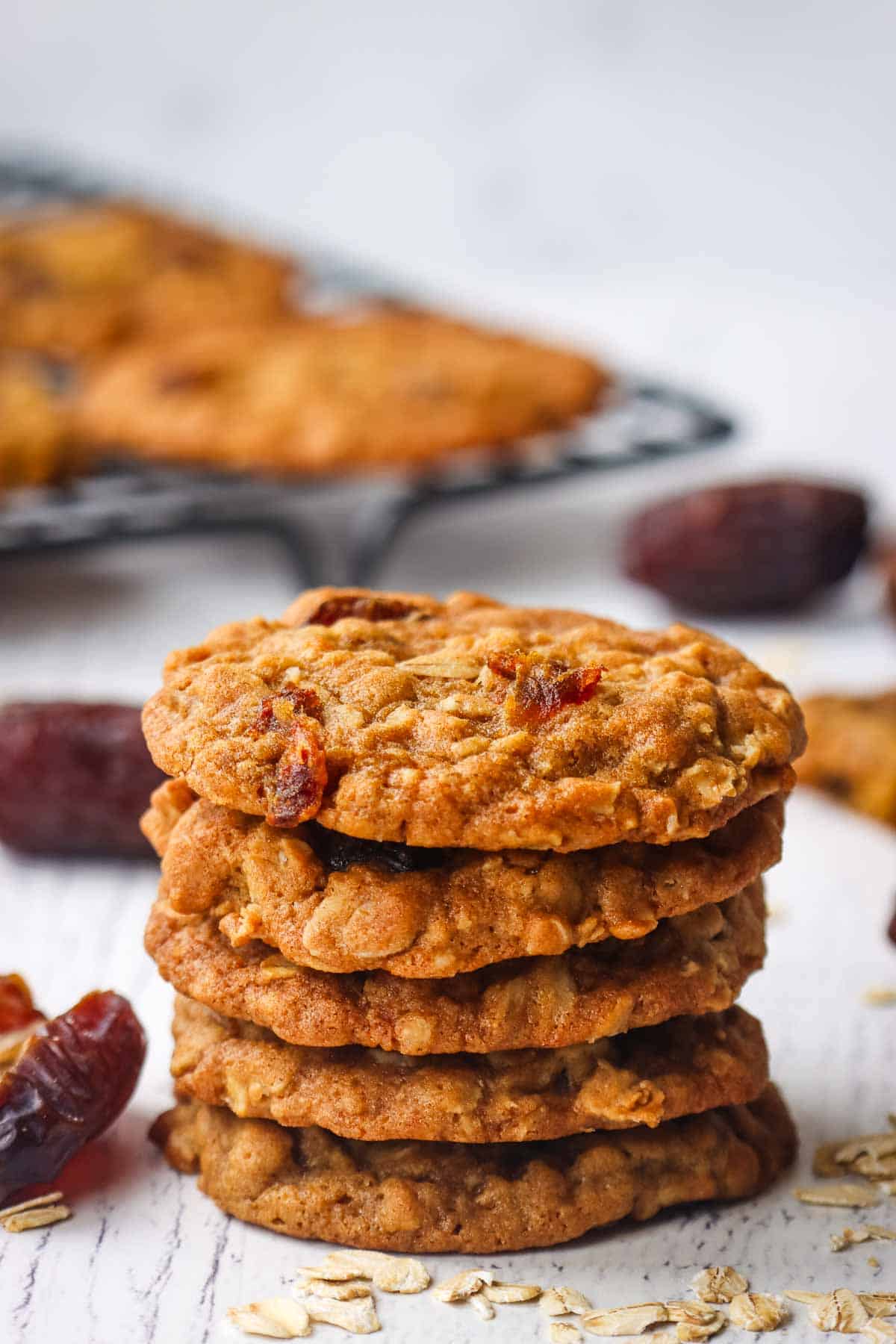 A stack of oatmeal date cookies on a plate.