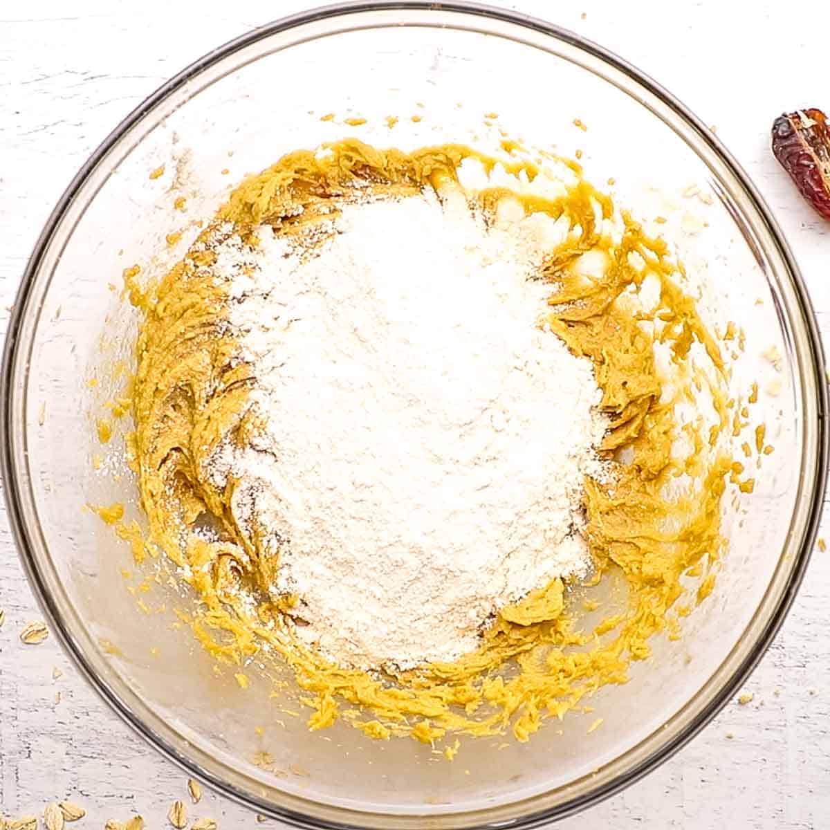 flour mixture added to the bowl with butter mixture