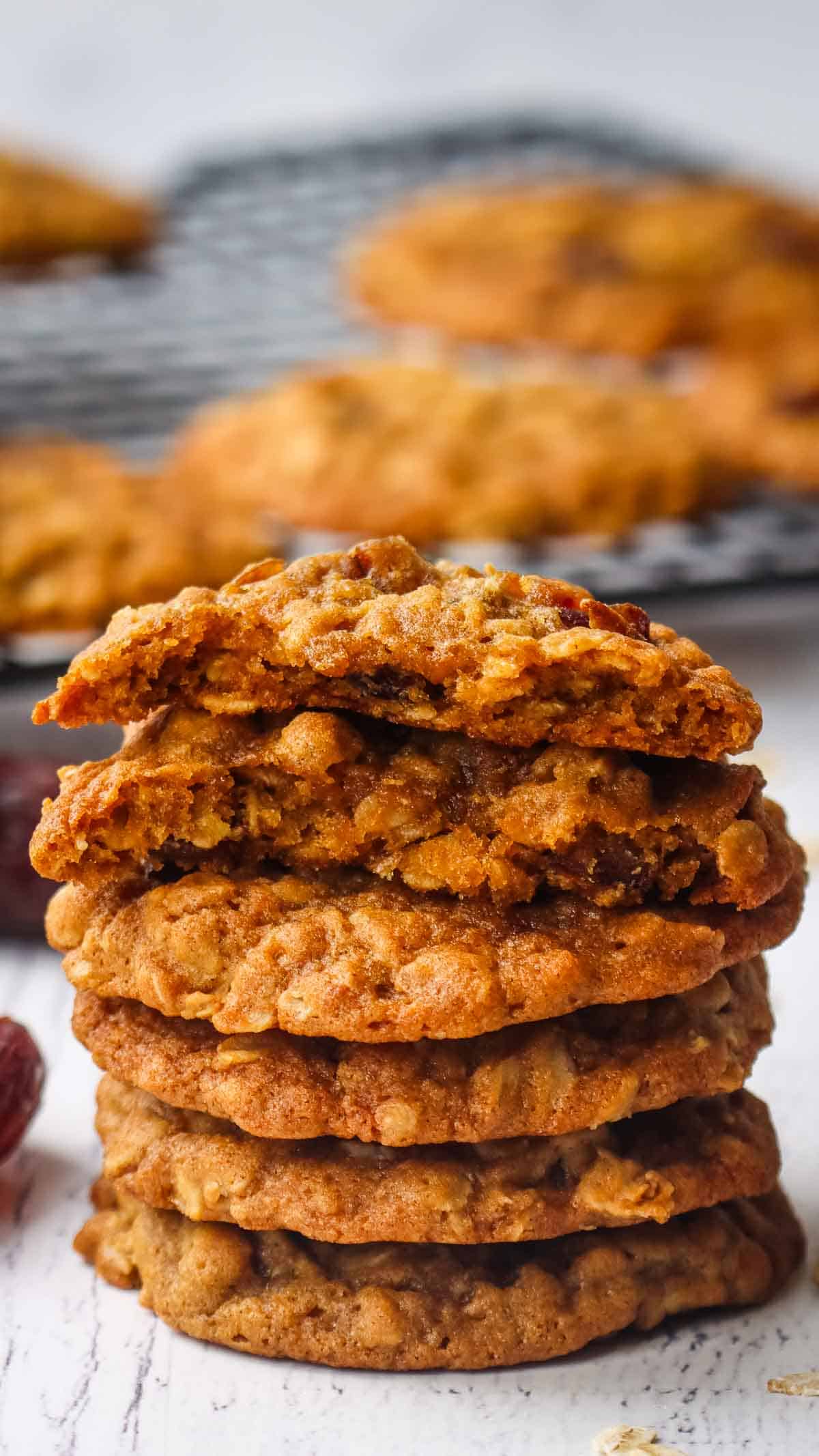 a stack of oatmeal date cookies with one cookie broken in half