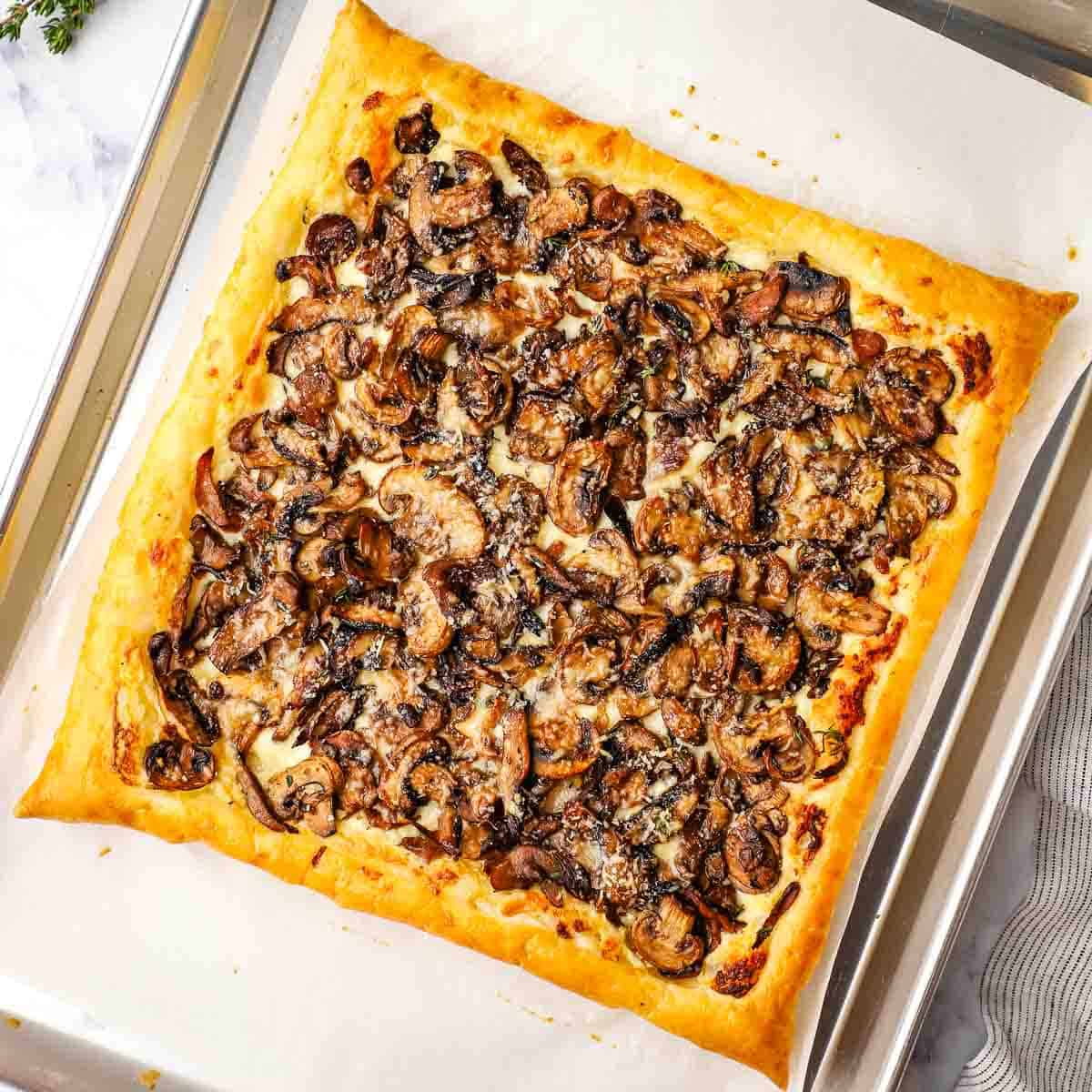 baked mushroom tart on a parchment lined baking sheet