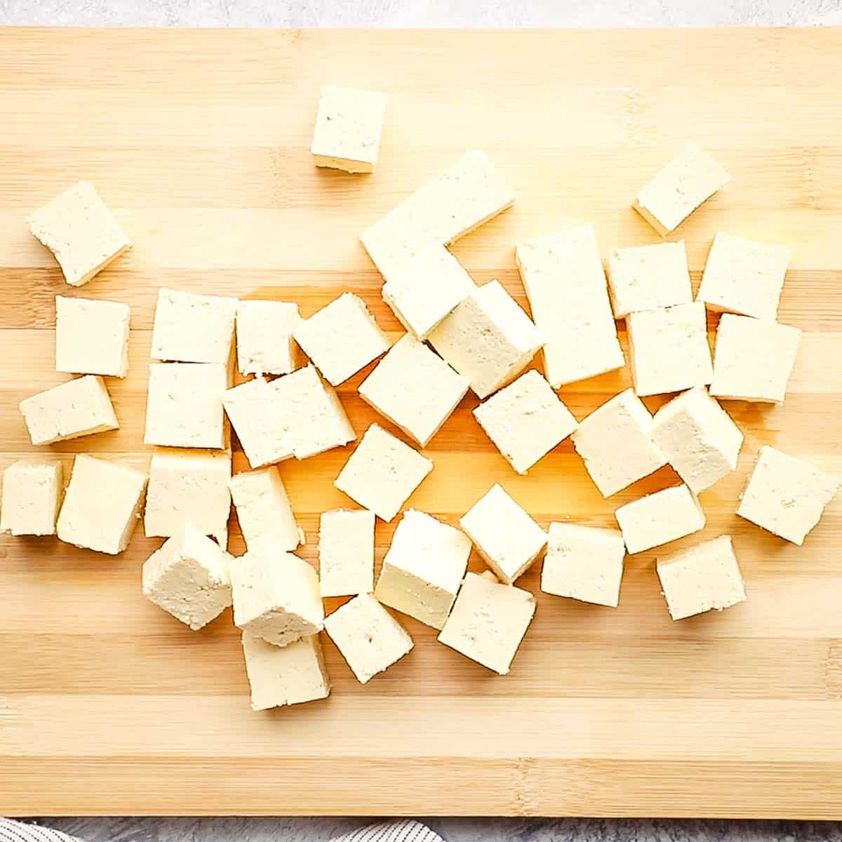 tofu cubes placed on a cutting board