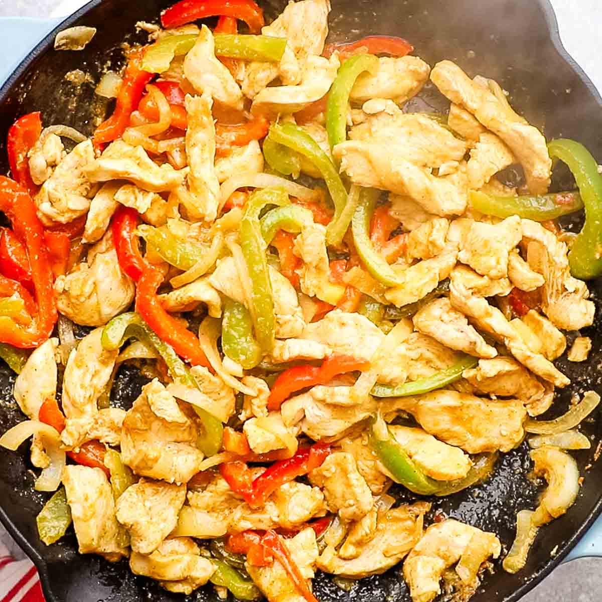 cooked chicken fajitas in a cast iron skillet