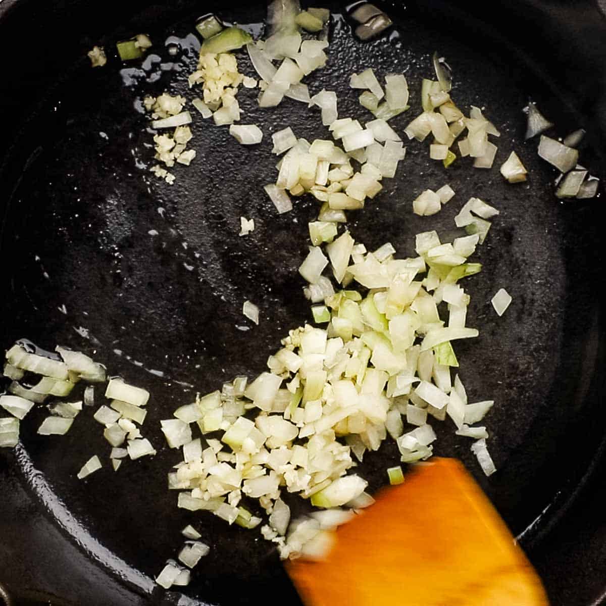 cooking onion and garlic in a cast iron skillet