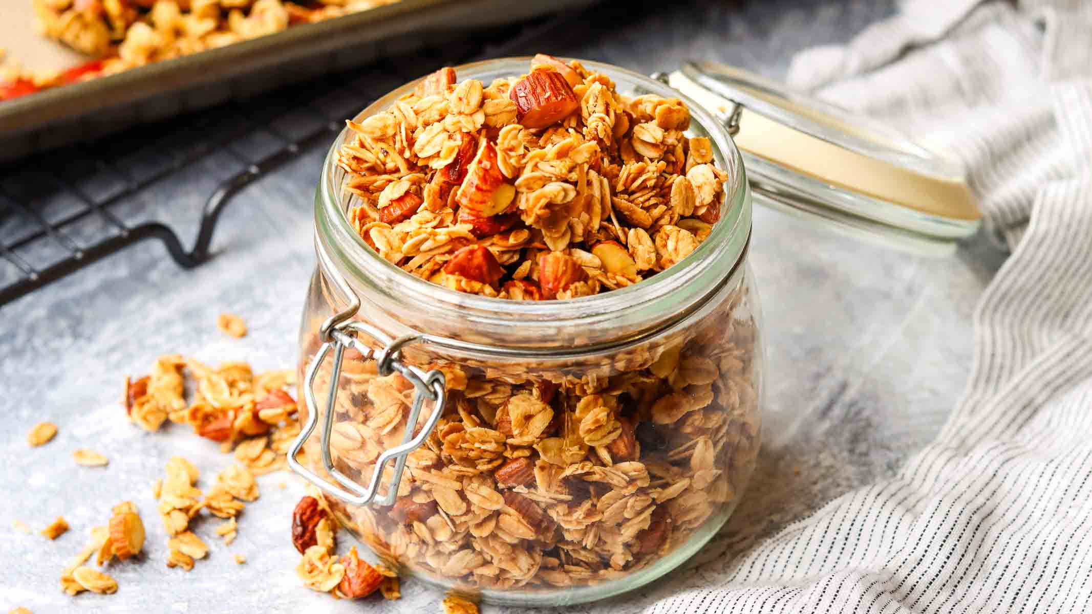 closeup view of an open jar of honey almond granola.