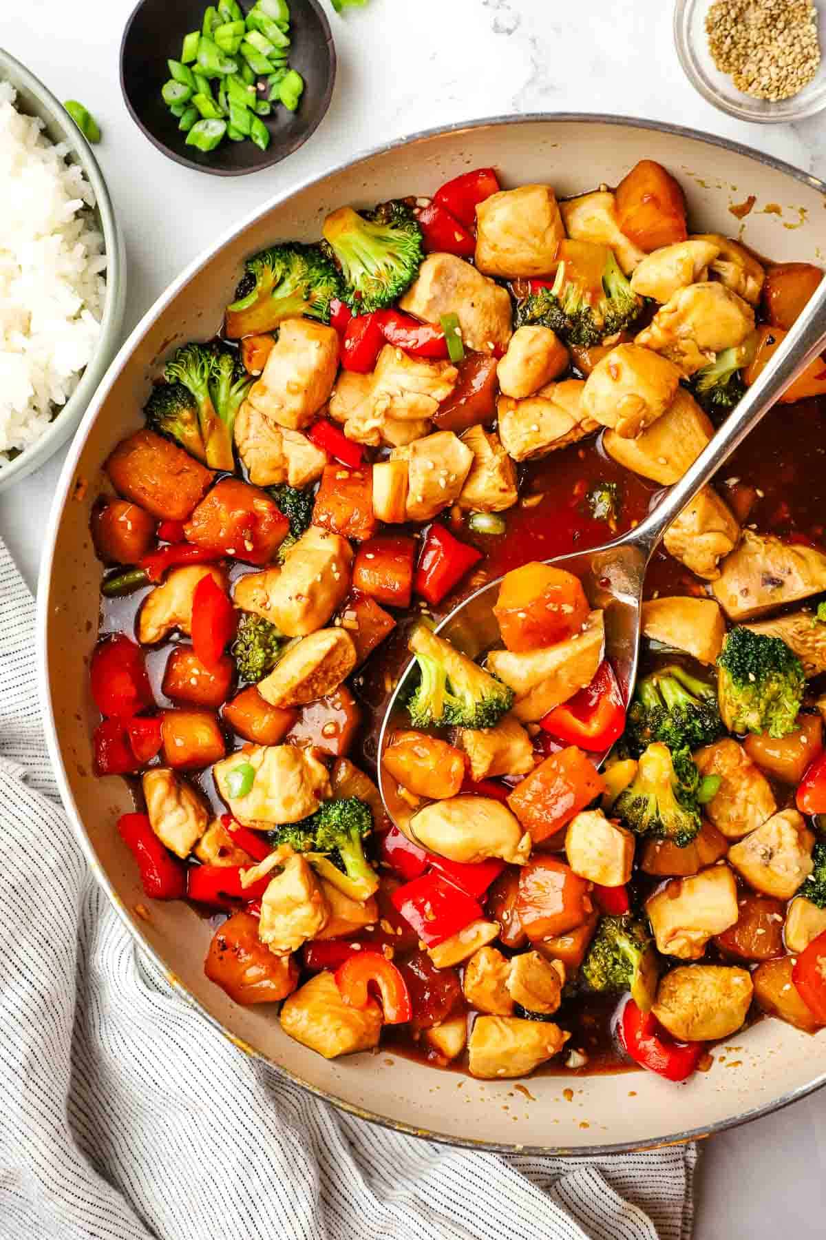 closeup overhead view of pineapple teriyaki chicken in a large skillet