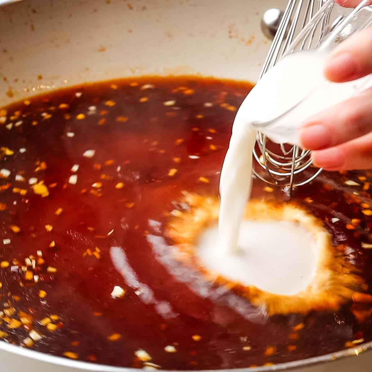 adding cornstarch slurry to teriyaki sauce