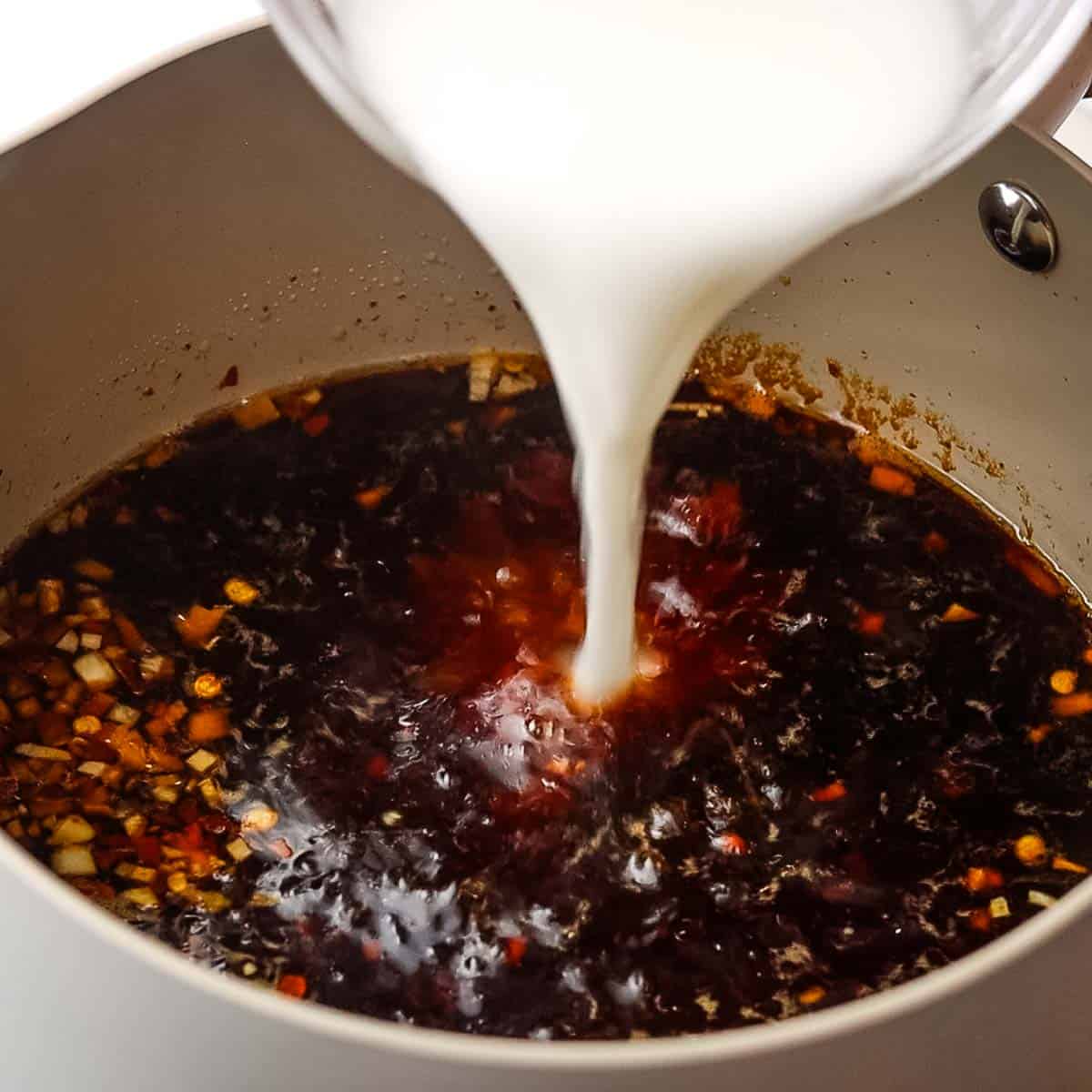 adding cornstarch slurry tot he simmering soy sauce mixture