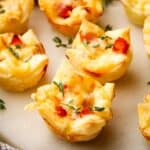 Bite size mini croque monsieur bites on a marble serving board.