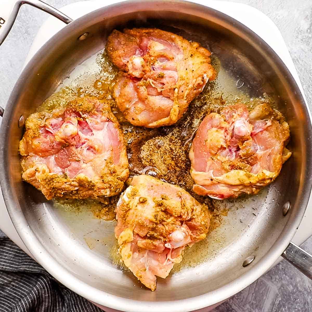 cooking chicken thighs in a skillet