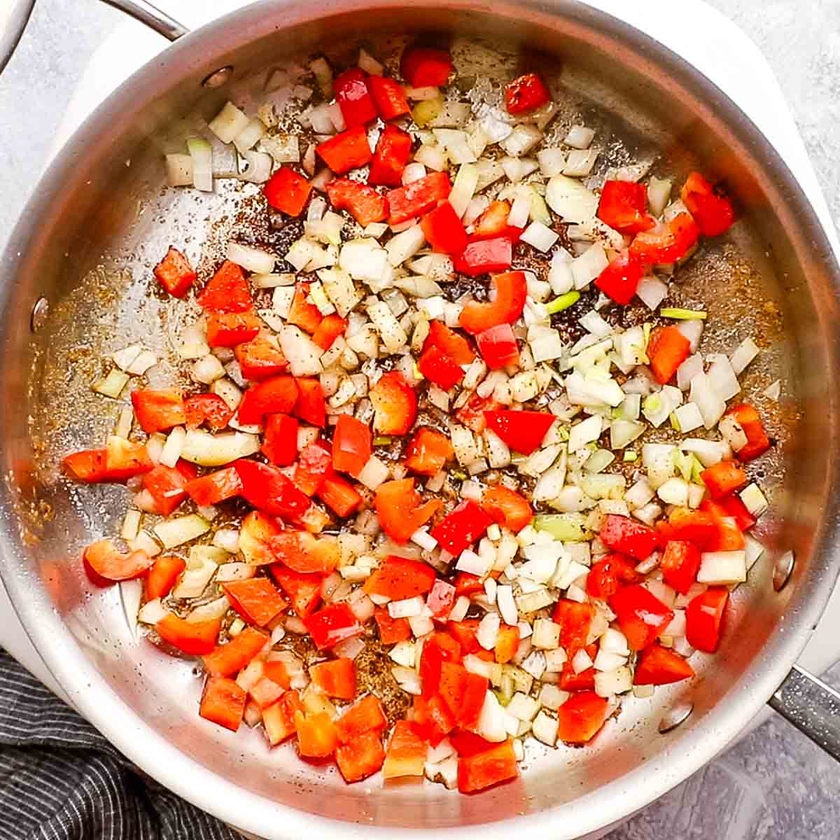 onions and bell peppers added to the pan