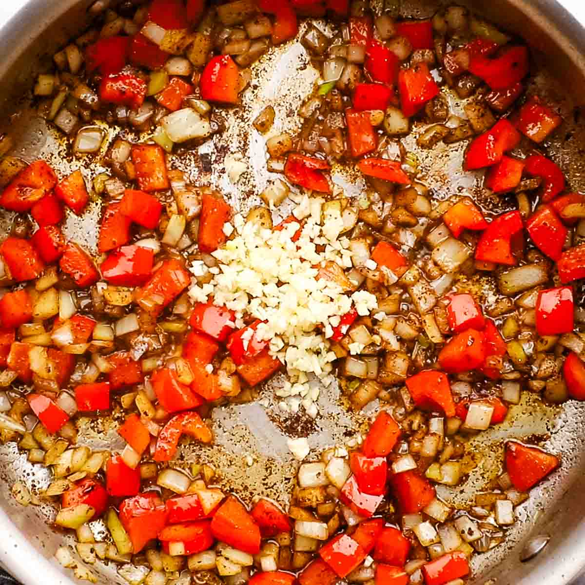 minced garlic added to the skillet with onions and bell peppers