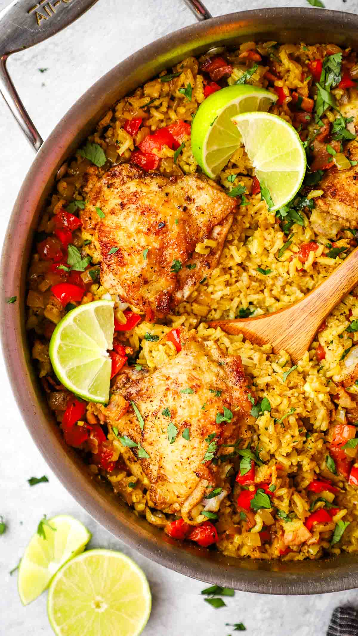 overhead view of a skillet with chicken thighs and rice