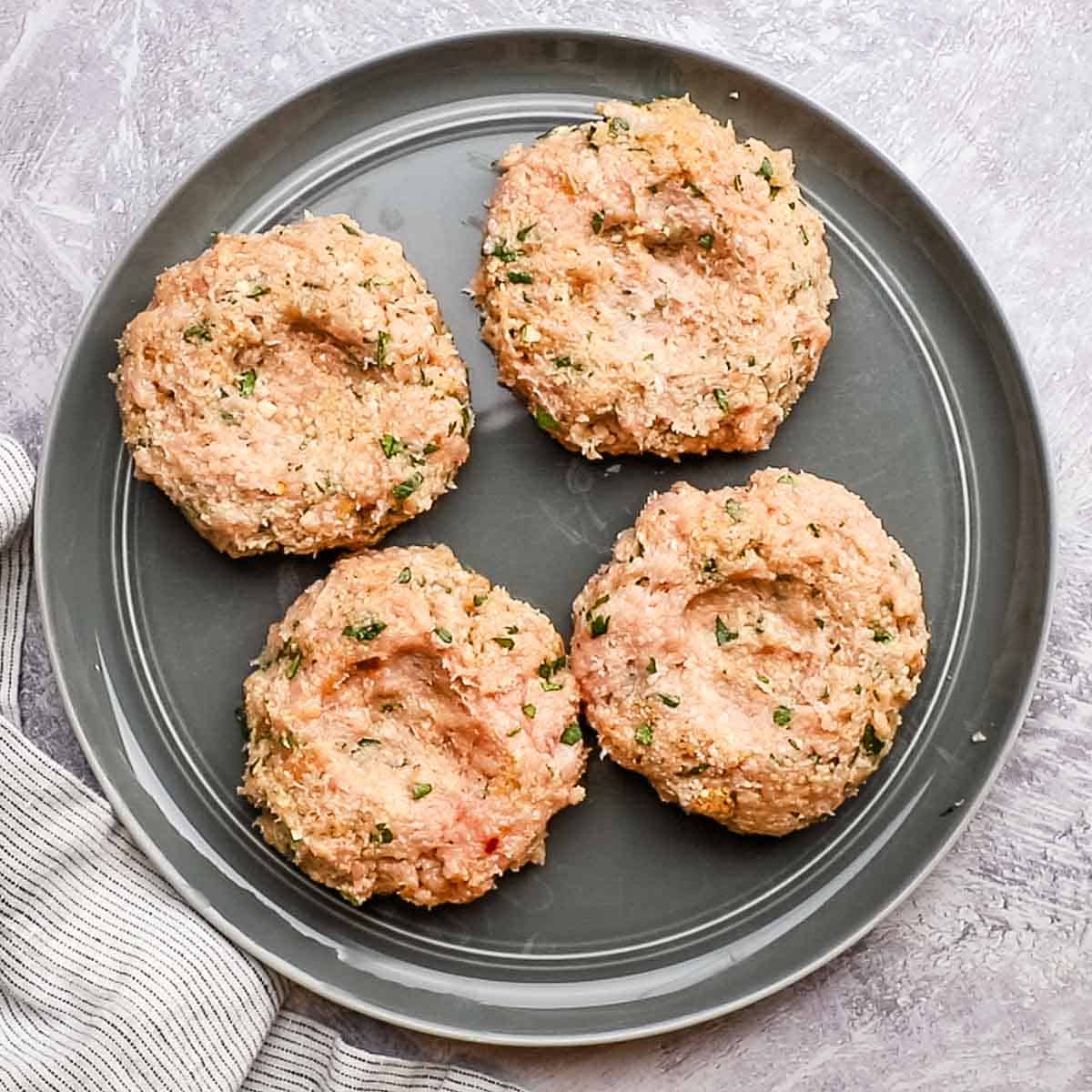 uncooked chicken patties on a plate