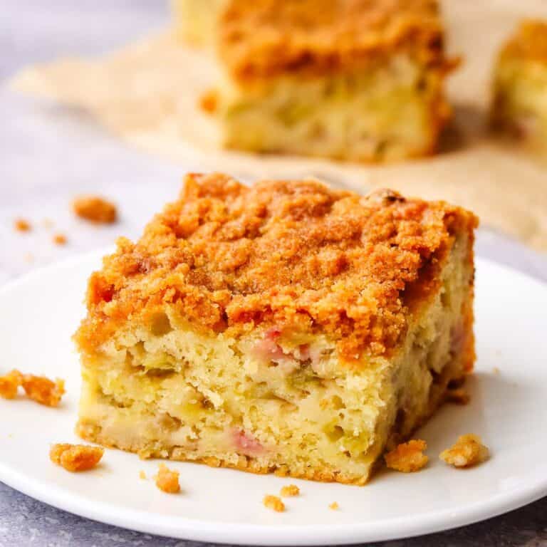 A piece of rhubarb crumb coffee cake on a white plate.