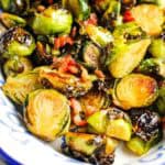 Closeup of roasted brussels sprouts in a serving dish.