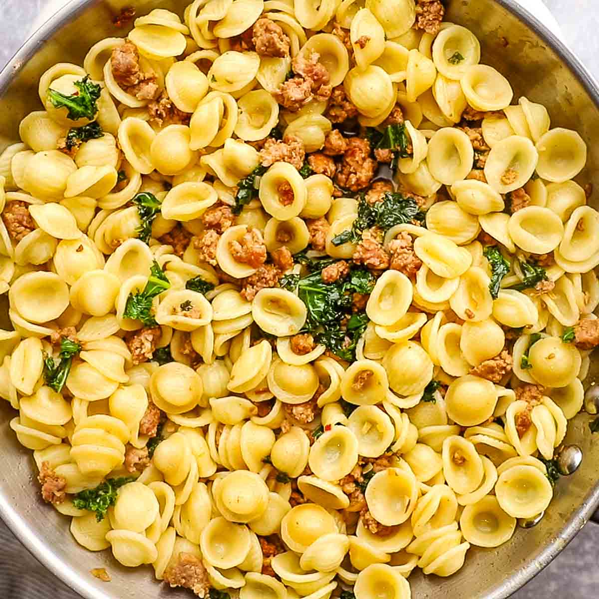 pasta added to the pan with the sauce