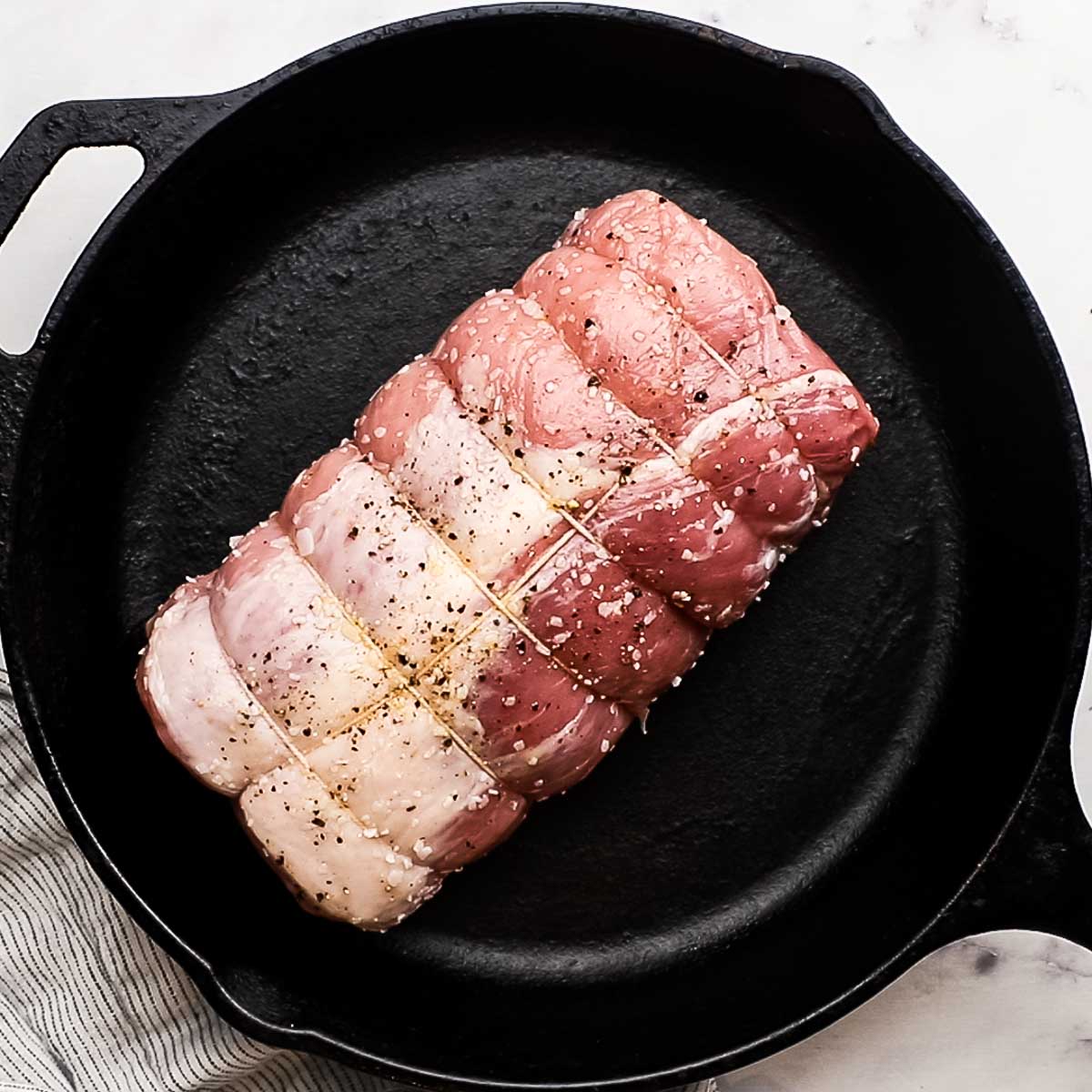pork loin placed in a cast iron skillet