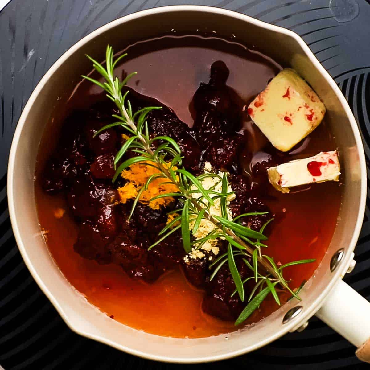 making cranberry glaze in a saucepan