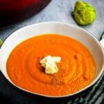 A bowl of carrot ginger soup with a dollop of yogurt