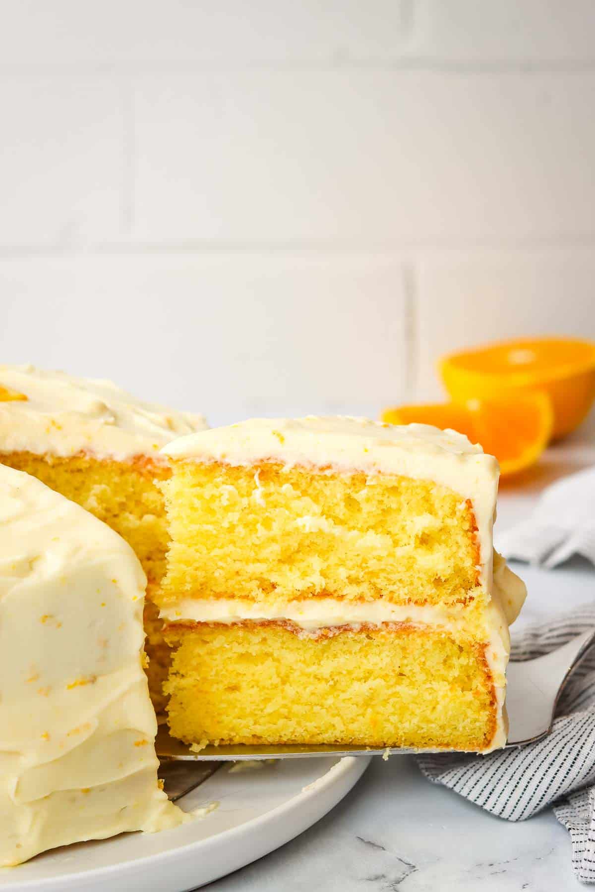 Taking out a slice of orange cake.