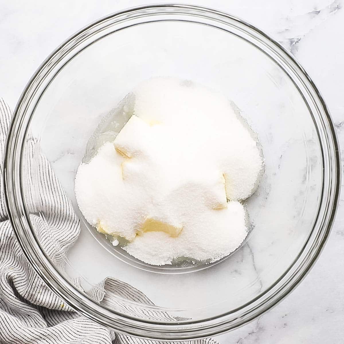 butter, oil, and sugar added to a bowl