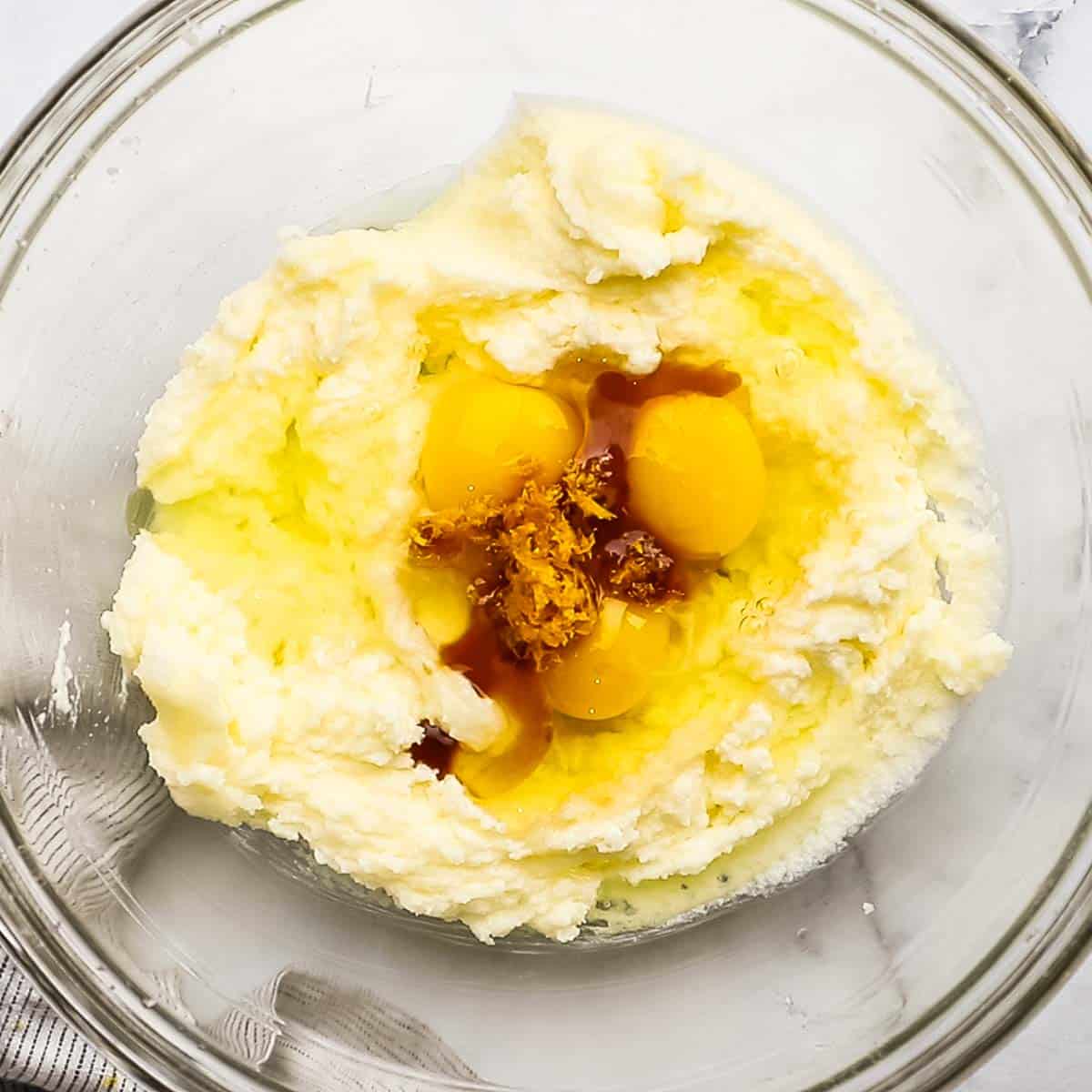 eggs. vanilla, and orange zest added to the creamed sugar