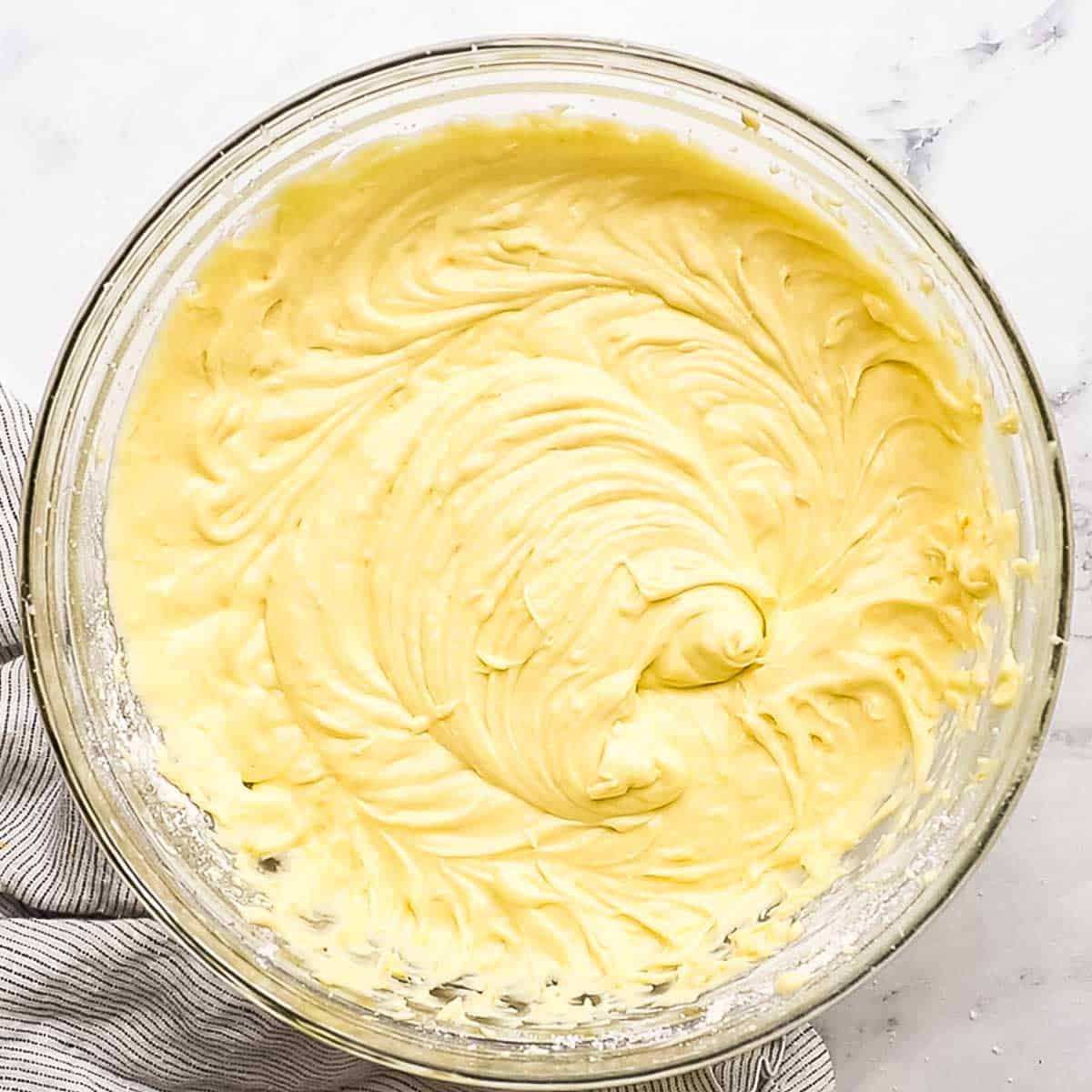 orange cake batter combined in a large bowl