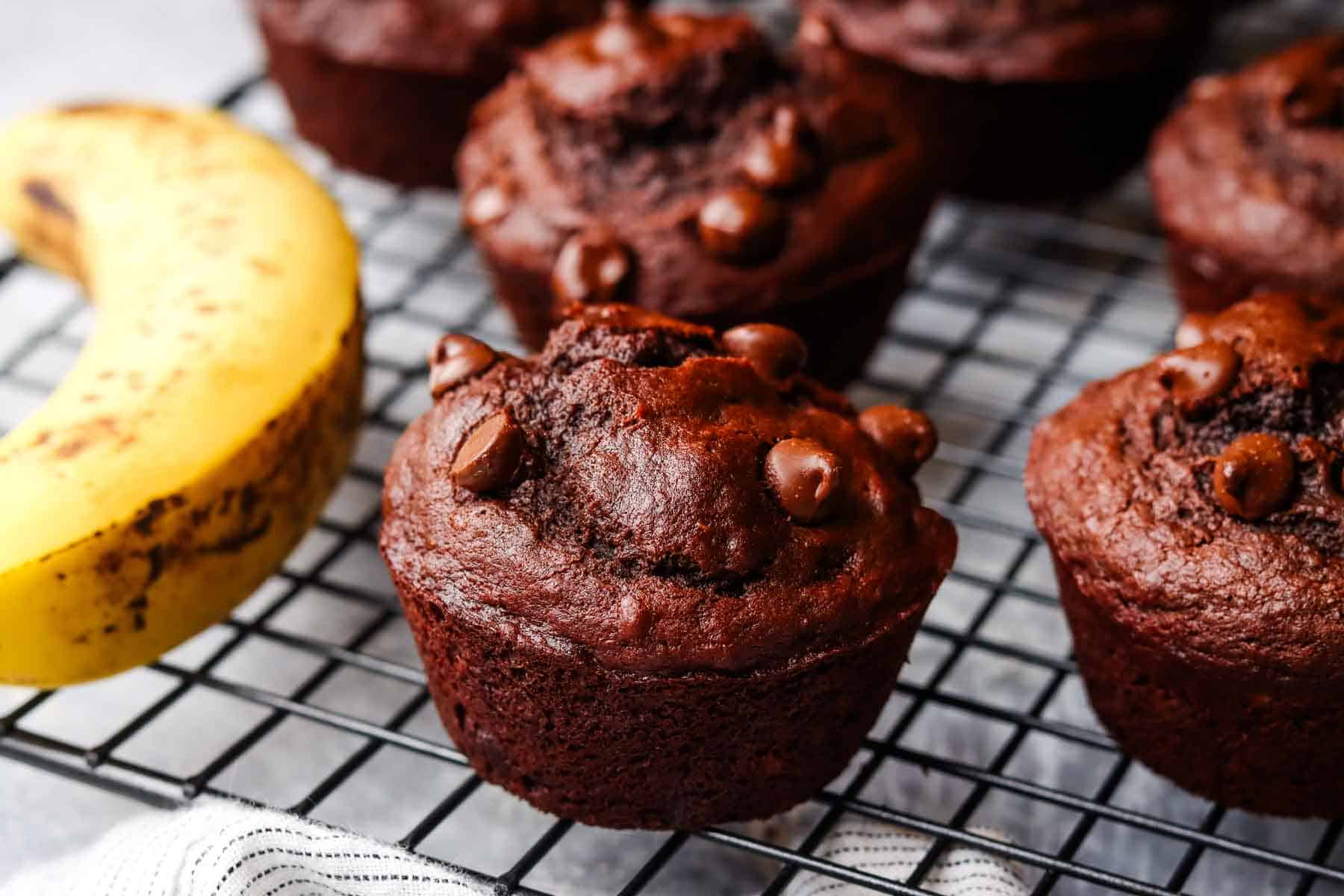closeup of a chocolate banana muffin on a cooling rack