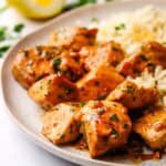A plate of Greek chicken bites served with rice.