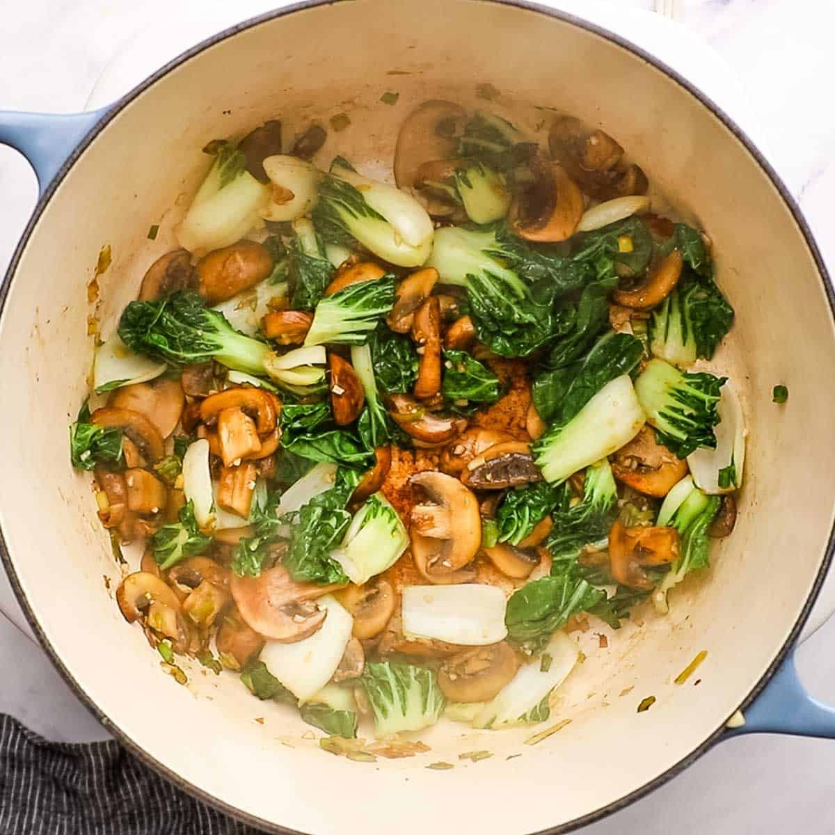 bok choy and garlic added to the pot