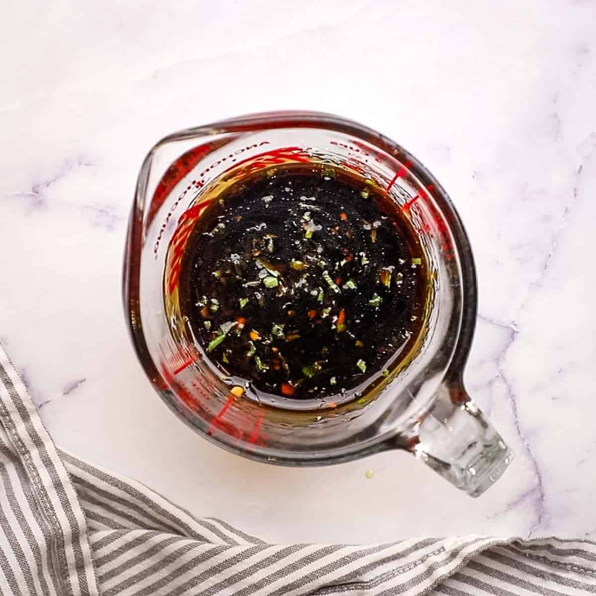 making marinade and dressing for pasta salad in a measuring cup