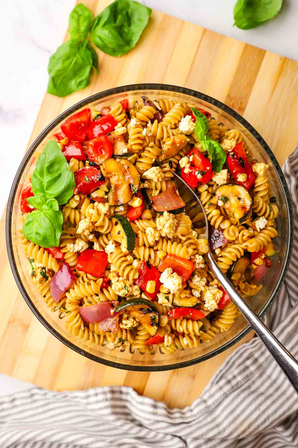 a bowl of pasta salad with grilled veggies