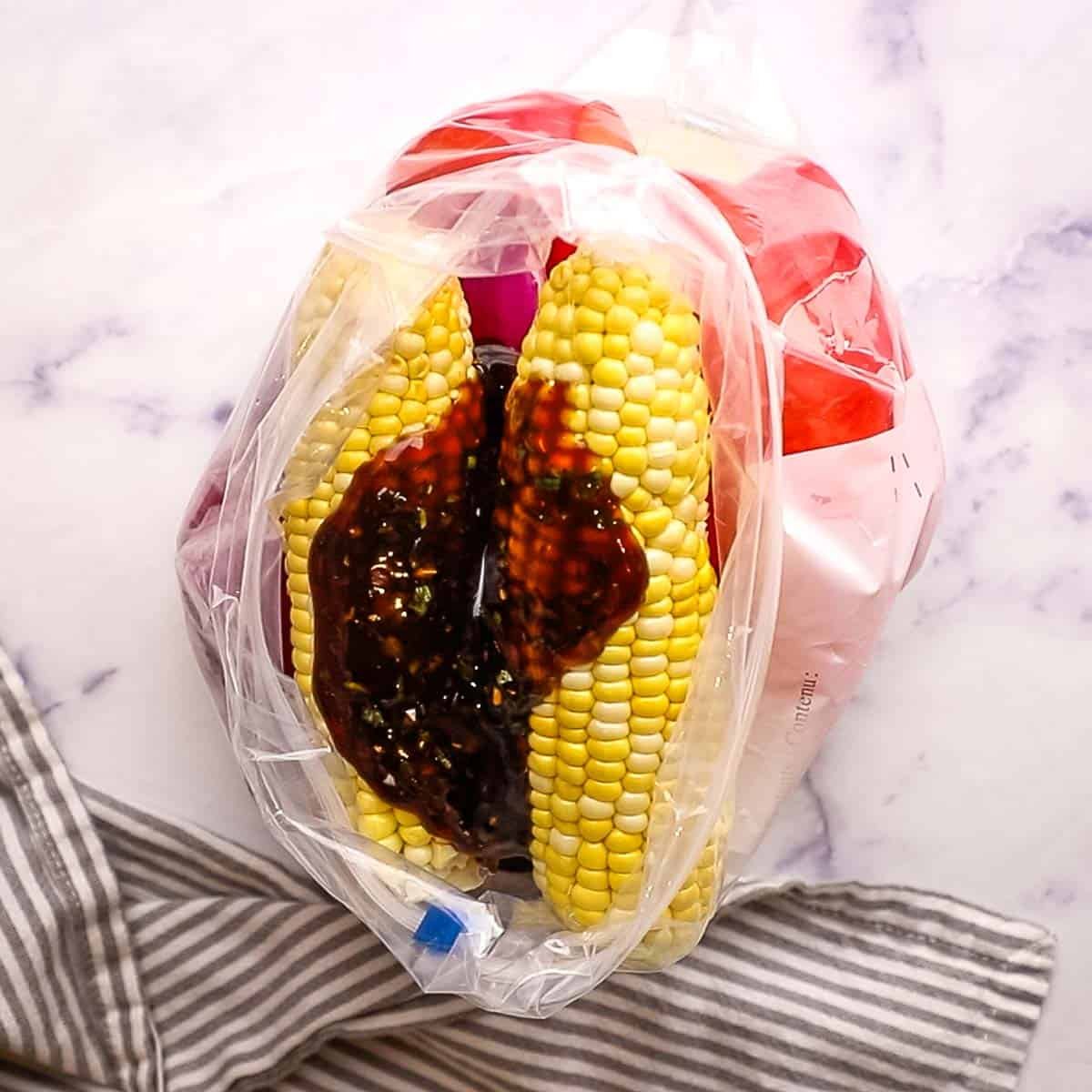 pouring marinade into a resealable bag with the vegetables
