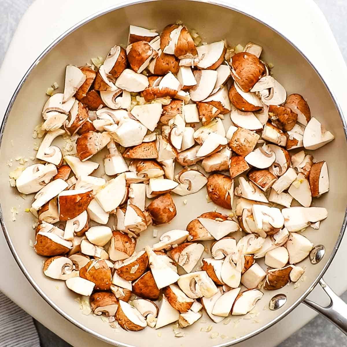 mushrooms added to the pan with shallots and garlic