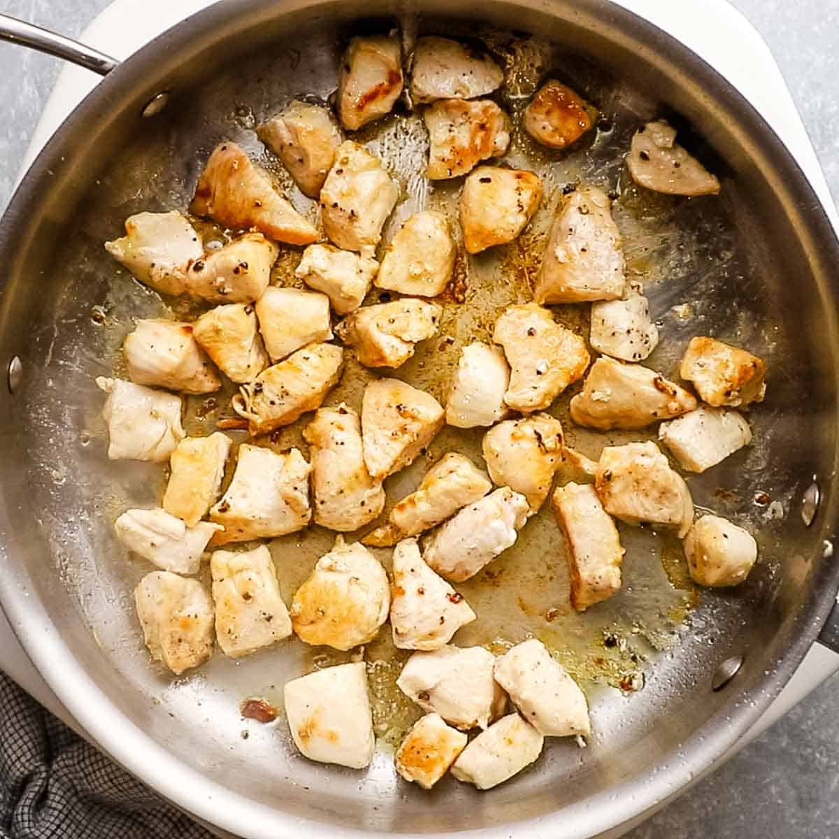 chicken cooking in a skillet